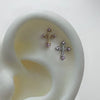 Pink gem cross piercing