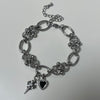 Spike cross heart piercing bracelet