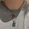 Blue swirl star necklace